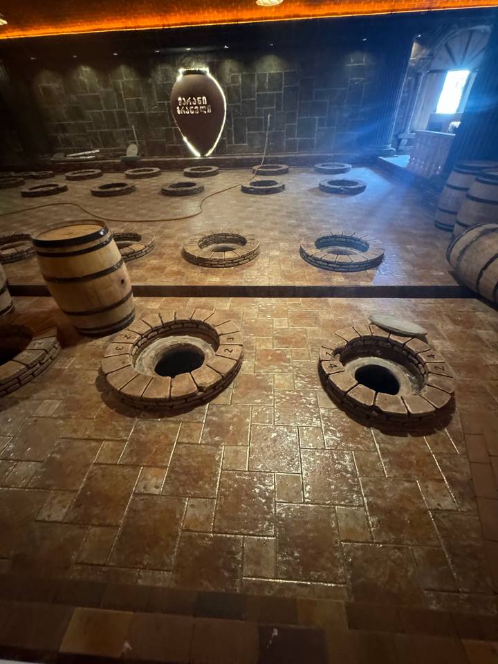 A room with circular artifacts or wine barrels.