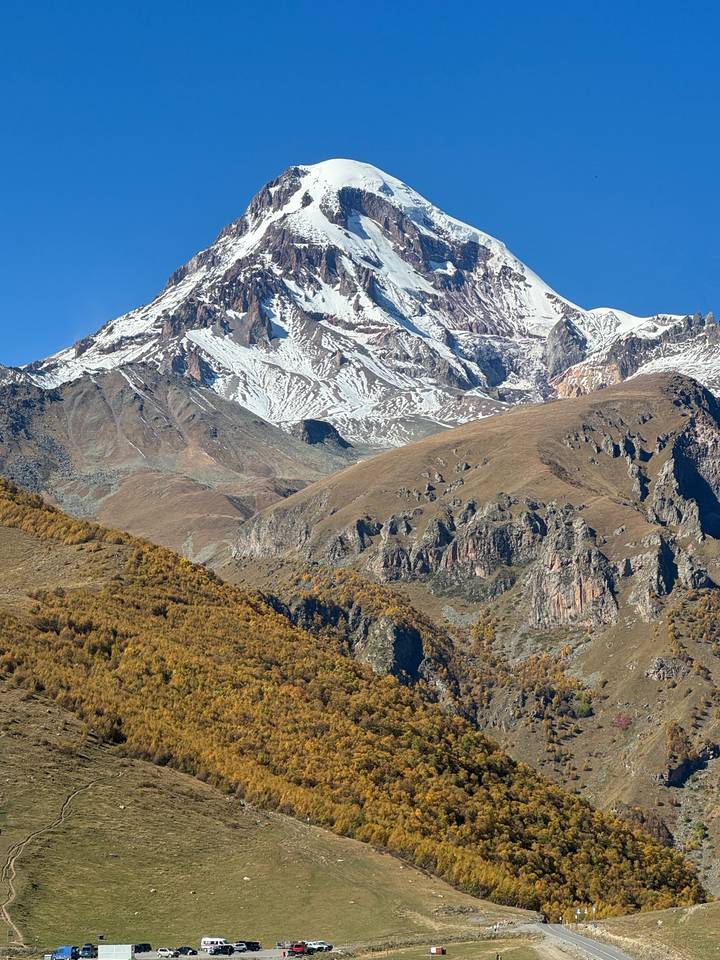 A snow-capped mountain under a clear sky.