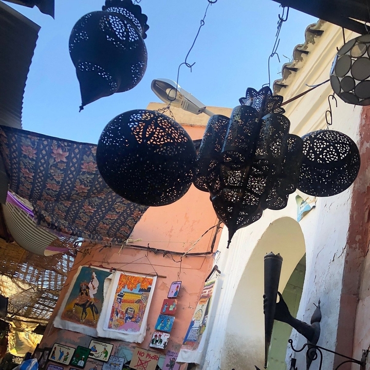 Ornate lanterns hanging in a covered market space.