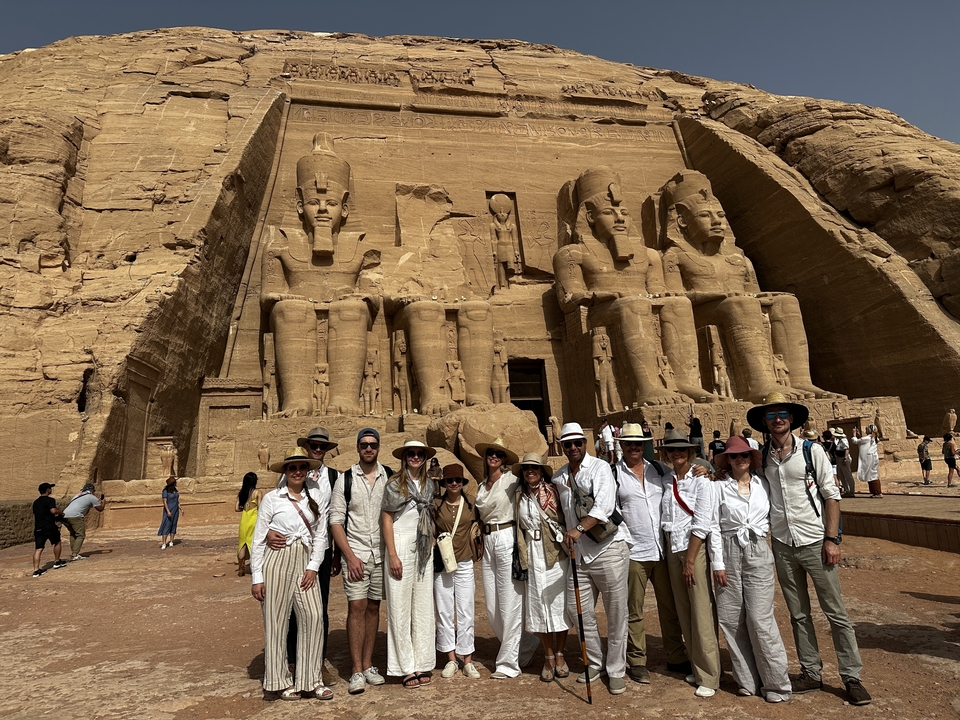 Group posing in front of Abu Simbel's massive statues.