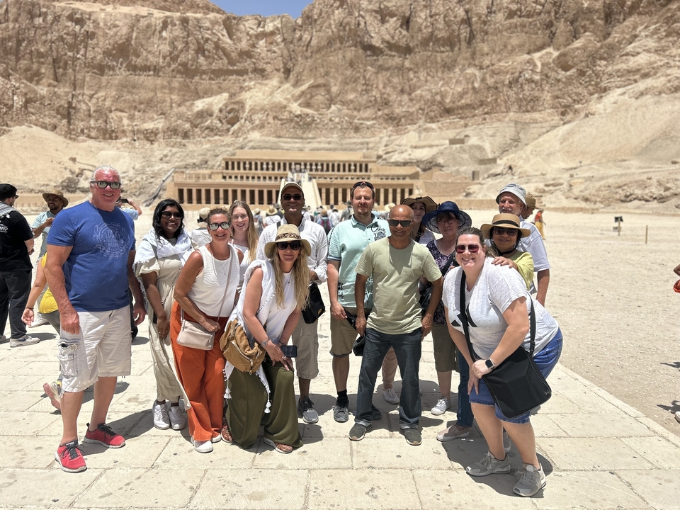 Tourists posing in front of the Temple of Hatshepsut.