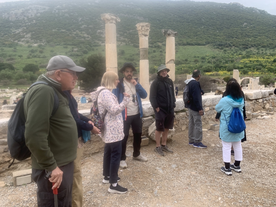Tourists standing at historical ruins.