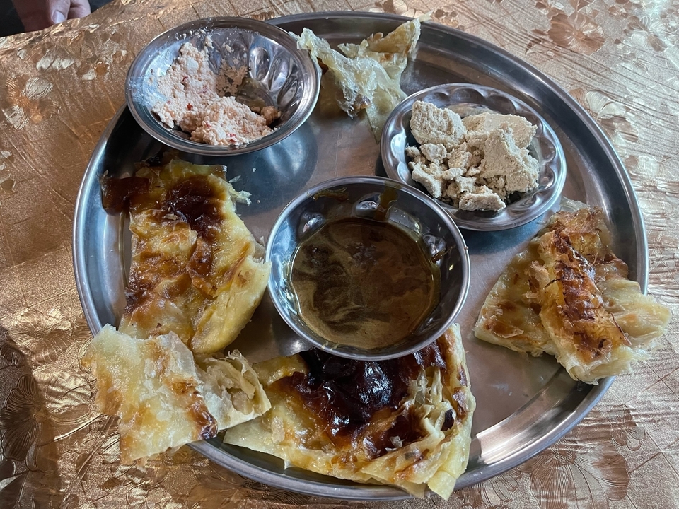 Plate with traditional bread and various dips.