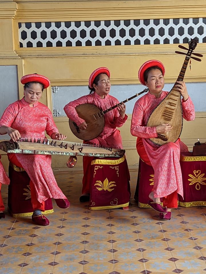 Traditional musicians performing with instruments.