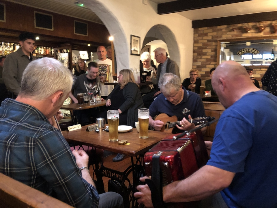 People playing music in a lively pub setting.