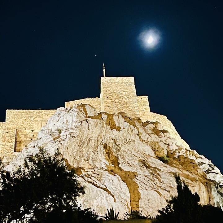 Illuminated historical structure at night.