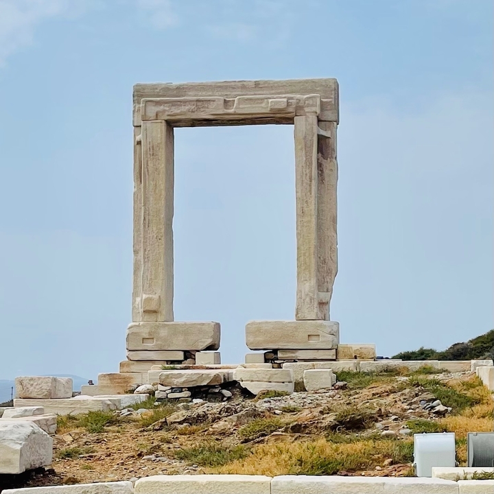 Ruins of an ancient stone structure under blue sky.