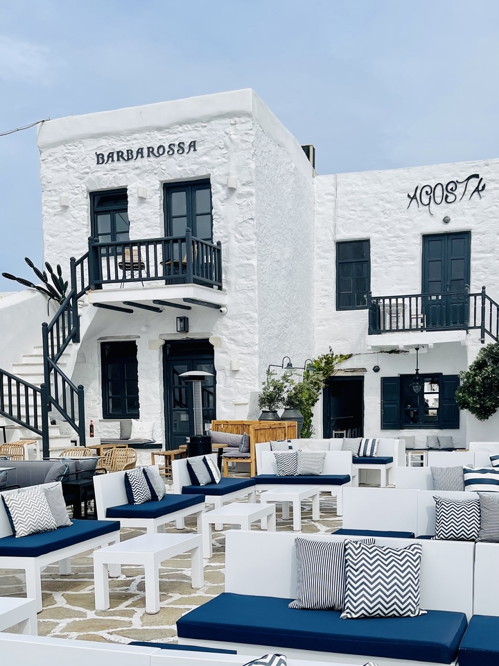 A white painted building with black accents on a sunny day.