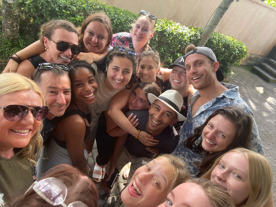 A group of friends smiling and embracing each other.