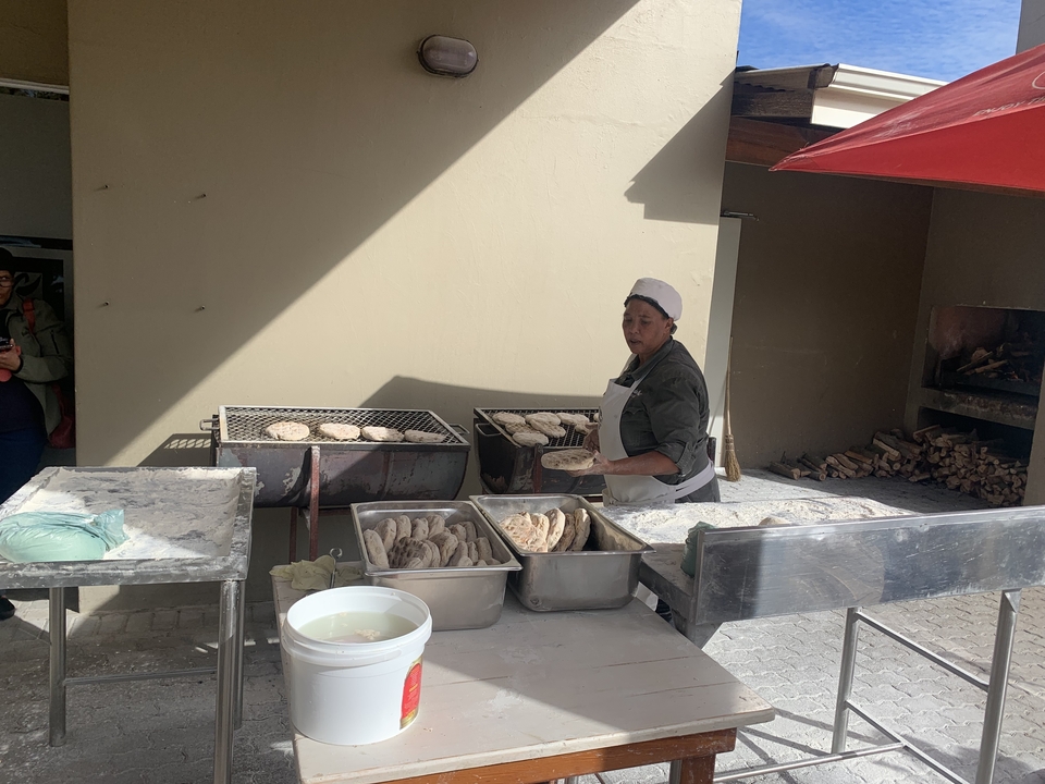 Woman making traditional flatbreads on an open fire.