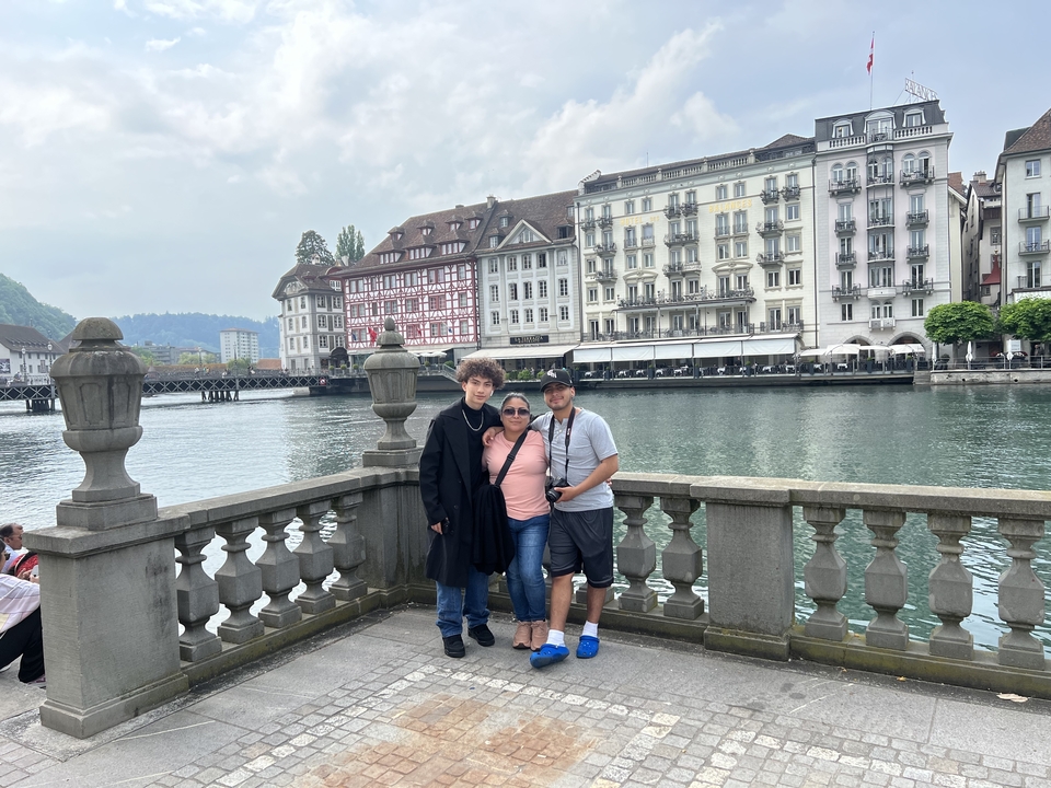Family posing near a river in Lucerne.