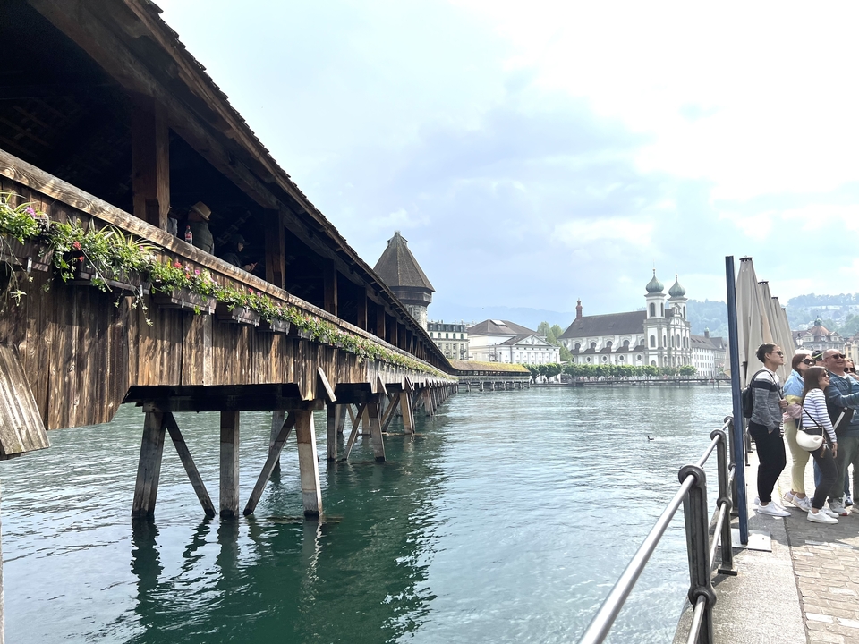 Bridge over the river with historic buildings in the background.