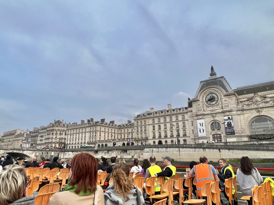 People in a boat enjoying a view of historic buildings.