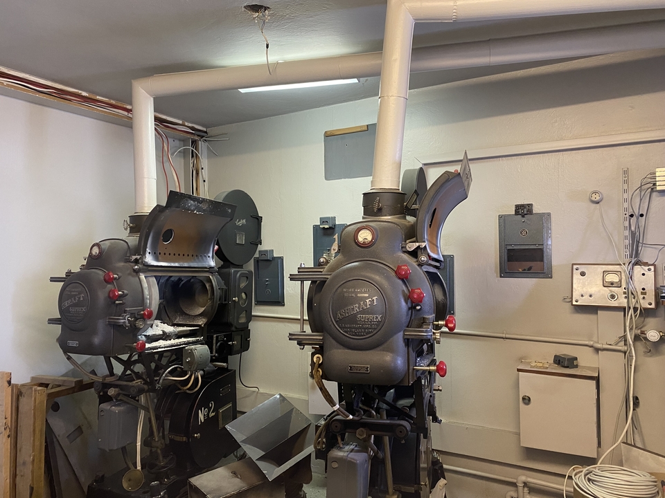 Vintage film projectors in a museum setting.