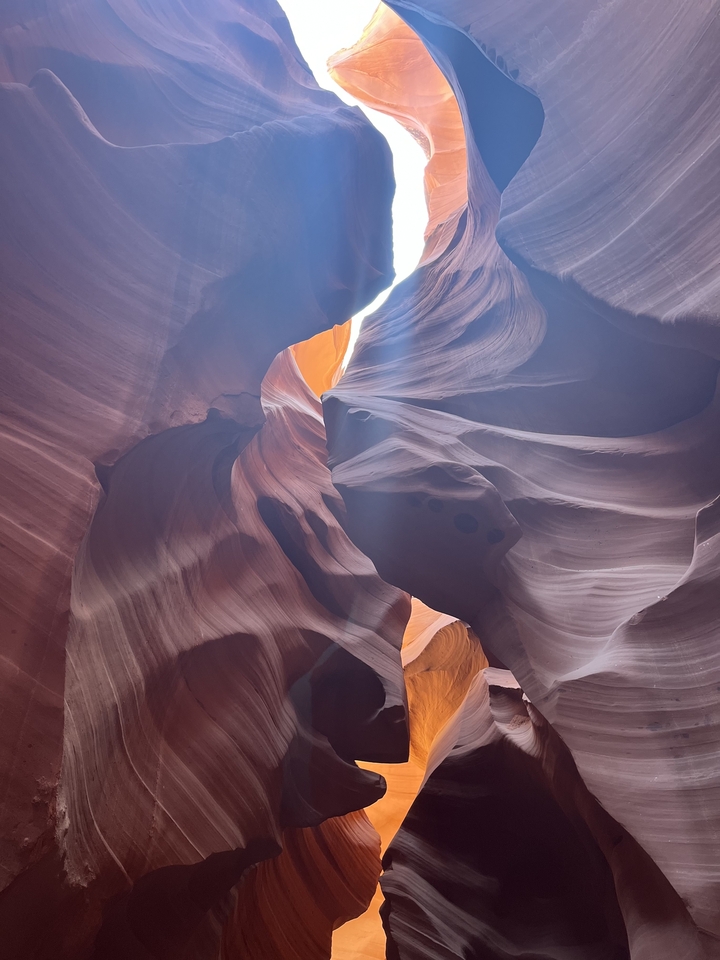 Colorful rock formations in narrow canyon.