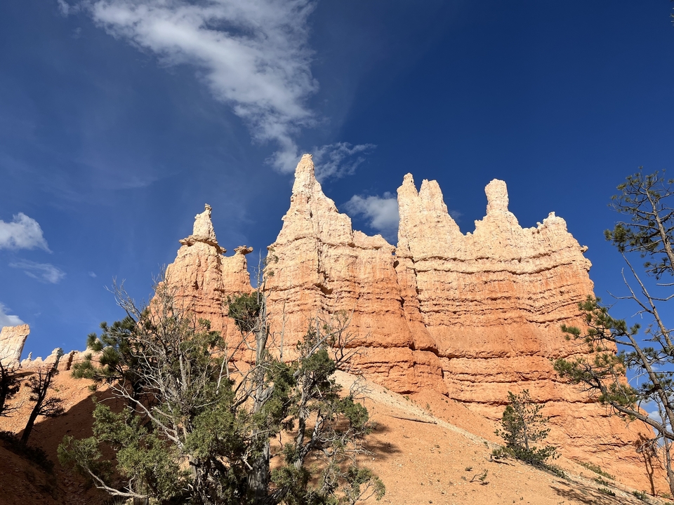 Hoodoo rock formations under a blue sky.