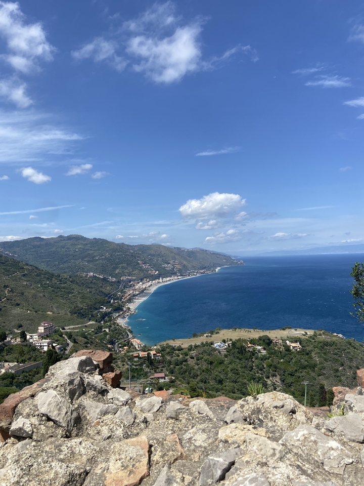 Coastal view of a beautiful bay with mountains in the background.