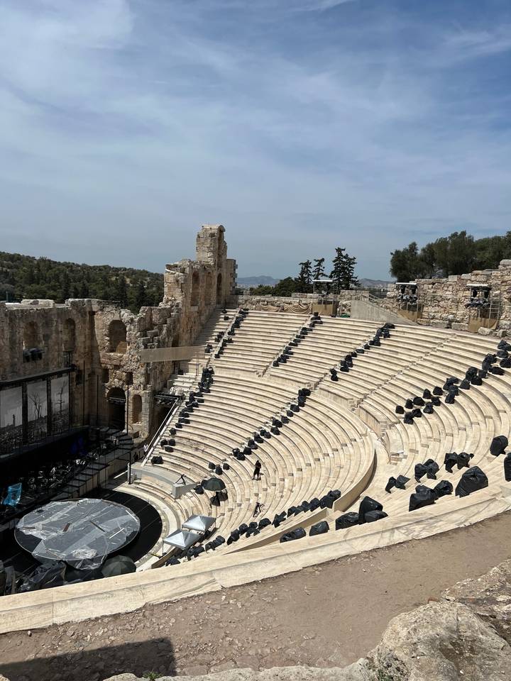 Ancient amphitheater with rows of stone seating.