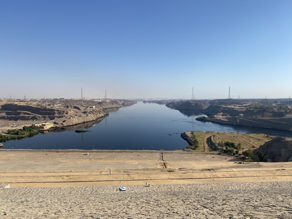 Wide river dam with vast landscape in the background.