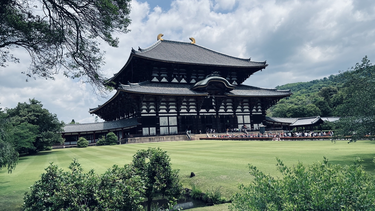Large historic temple structure in a manicured garden.