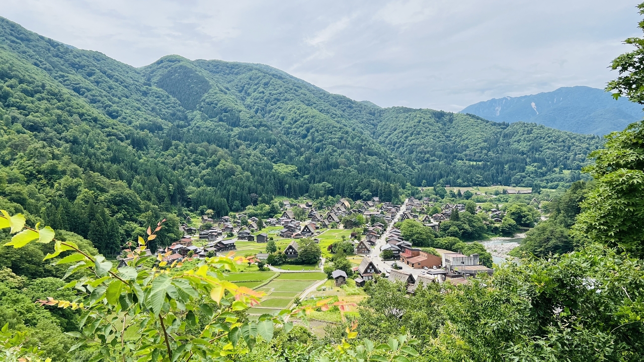 Scenic view of Shirakawago village surrounded by mountains.