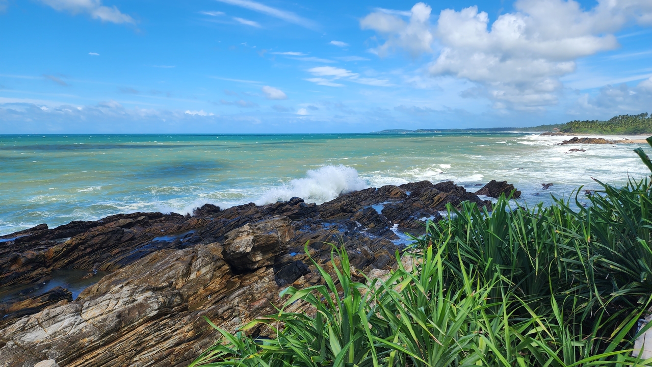 Rocky coastline with waves crashing against the rocks.