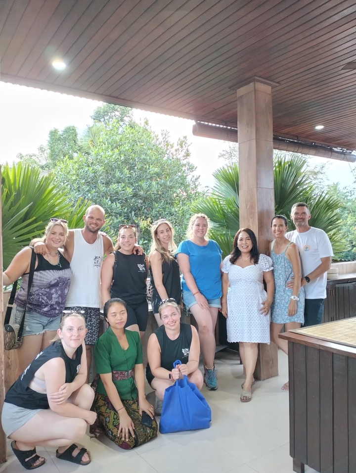 Group smiling together in an outdoor setting.