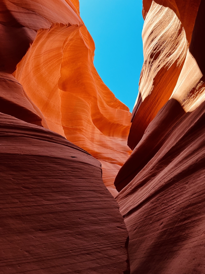 Vibrant rock formations with a bright sky at Antelope Canyon.