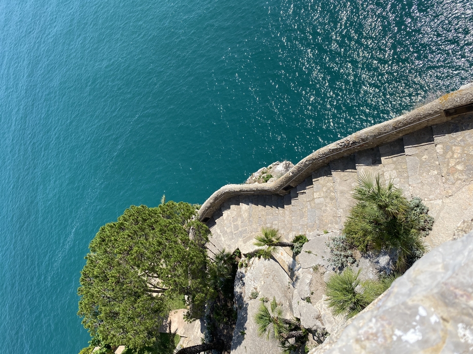 A scenic coastal pathway with blue water.