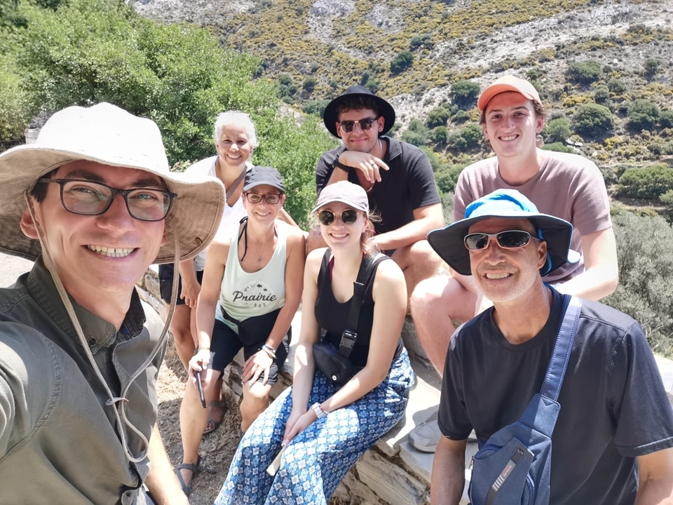 Group selfie in an outdoor setting with hills.