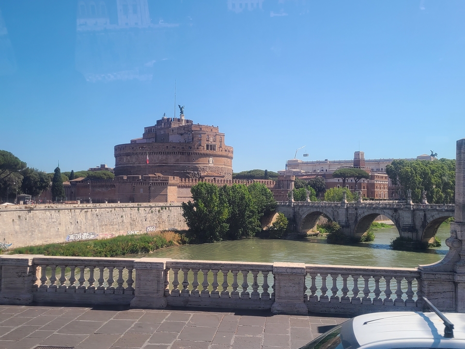 Historic castle with a bridge over a river.