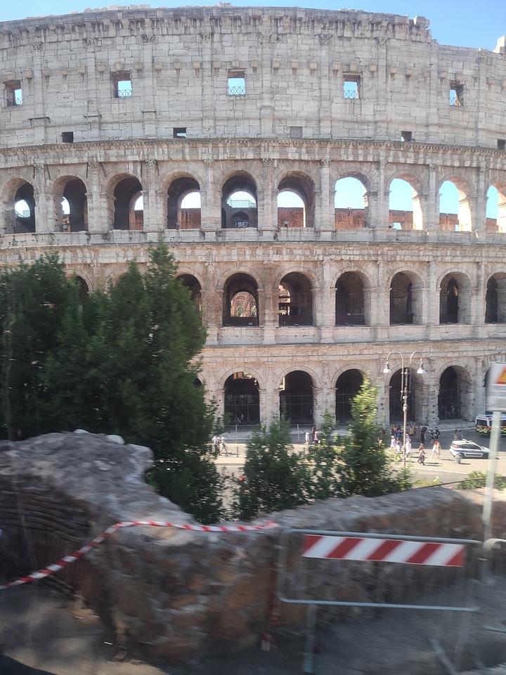 The Colosseum in Rome with tourists around.