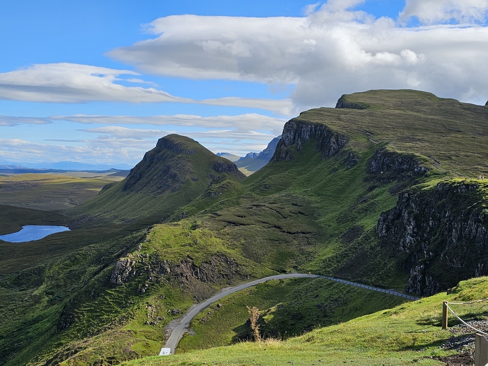 Majestic peaks with winding roads and hiking trails.