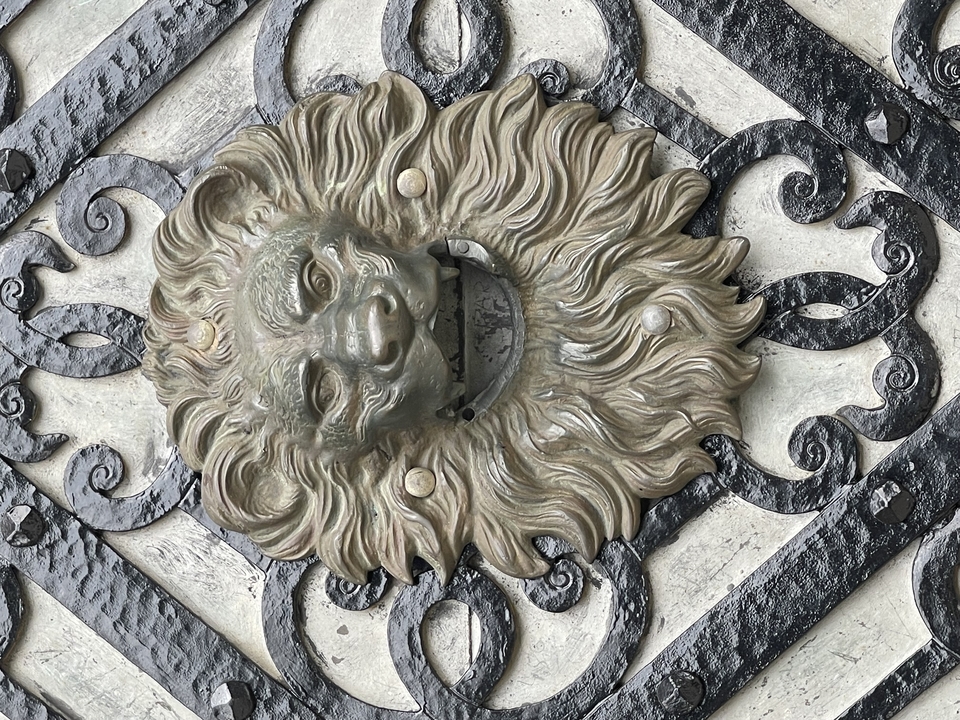 Decorative lion head sculpture on an ornamental door