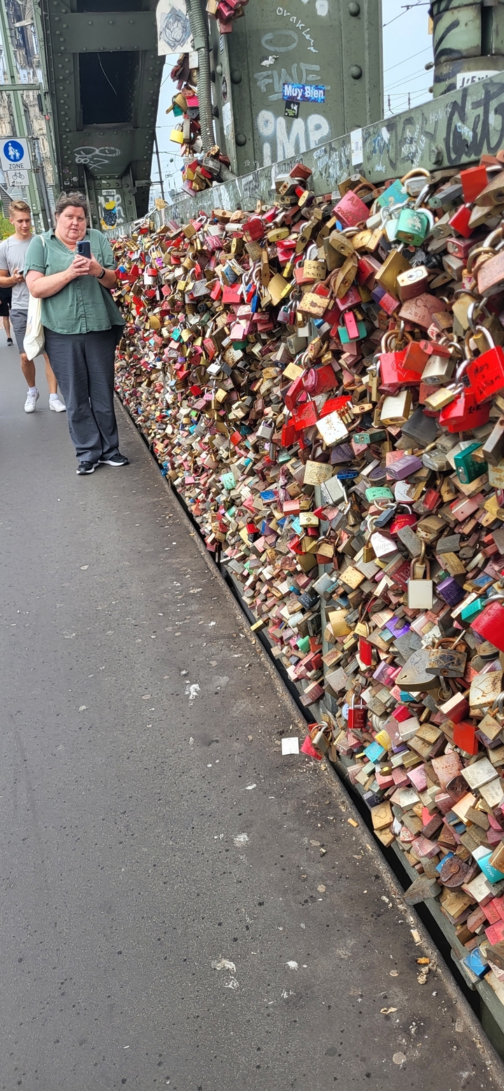 Wall of colorful locks with partially visible feet.