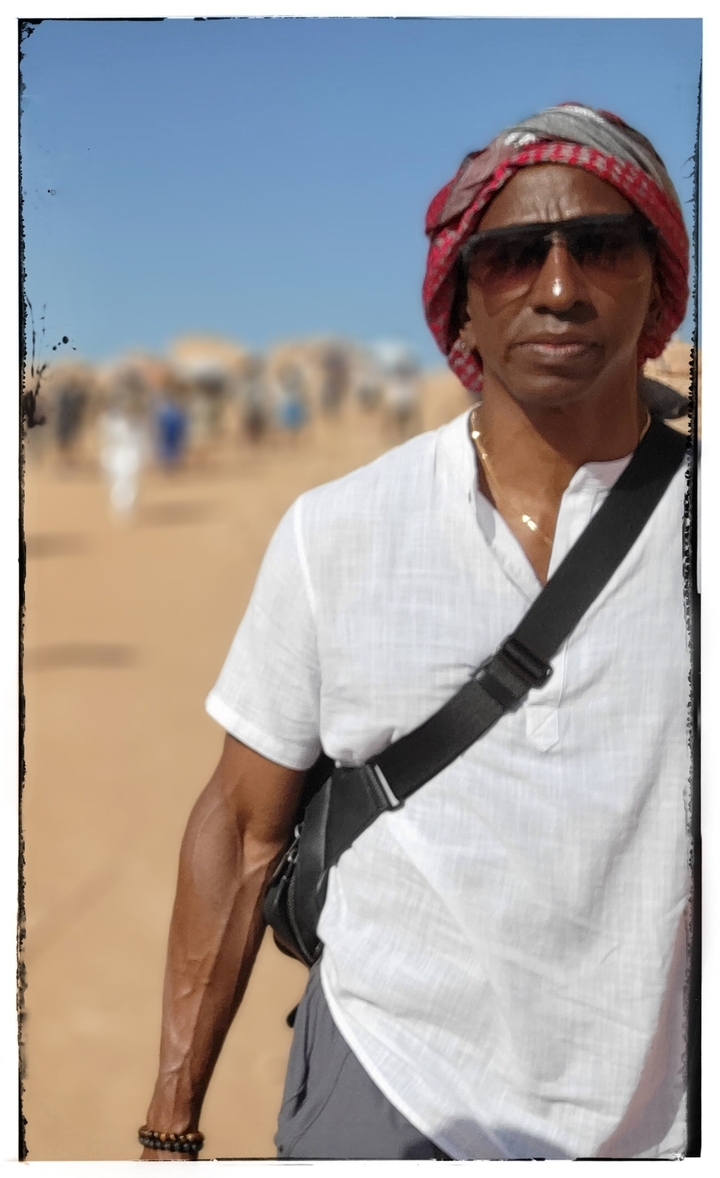 Person standing outdoors, photo has a frame effect.