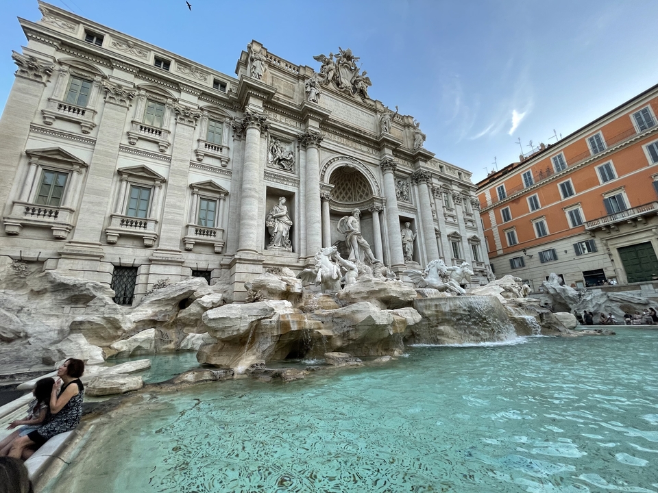 Trevi Fountain with tourists in Rome.