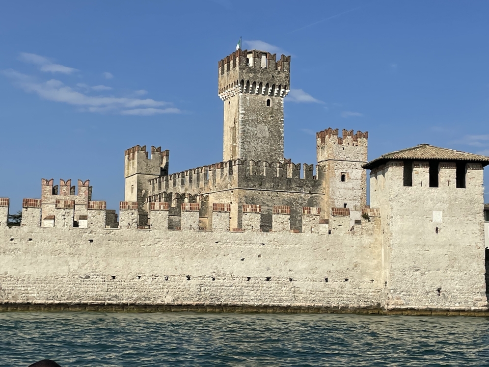 Medieval castle by the lake under a clear sky.