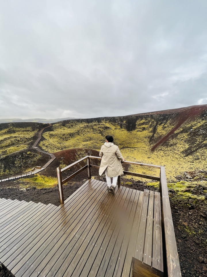 Man viewing scenic volcanic landscape.