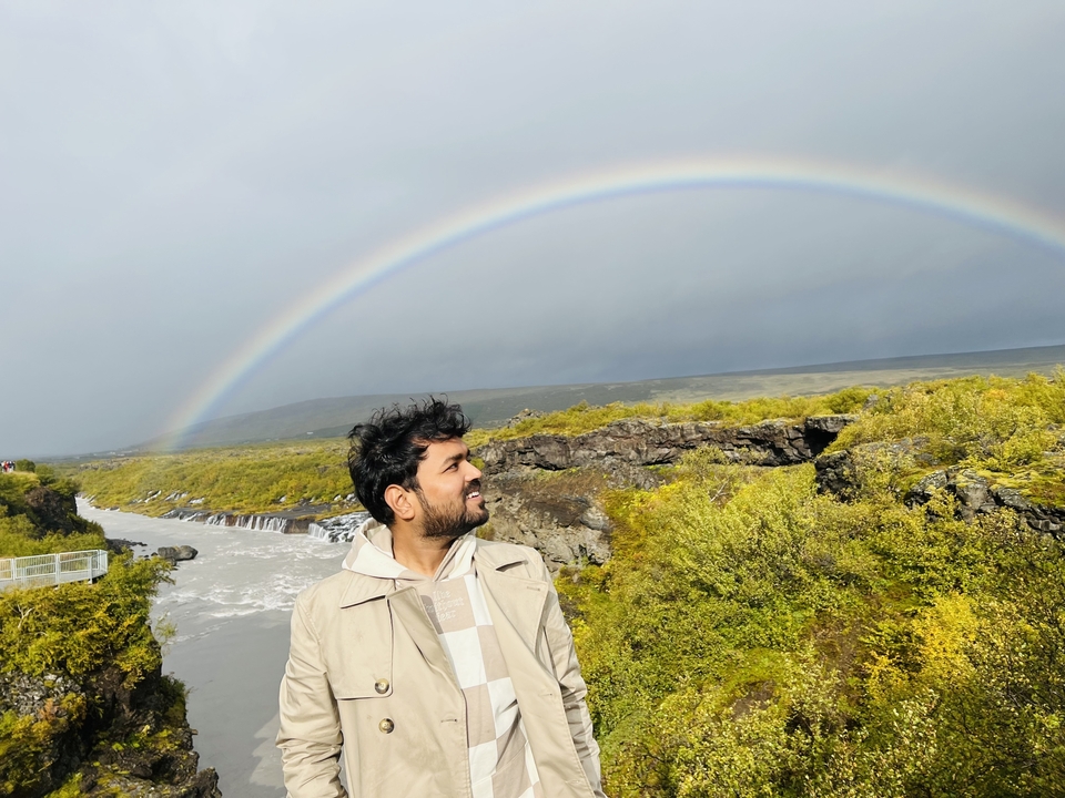 Man with a rainbow in the background.