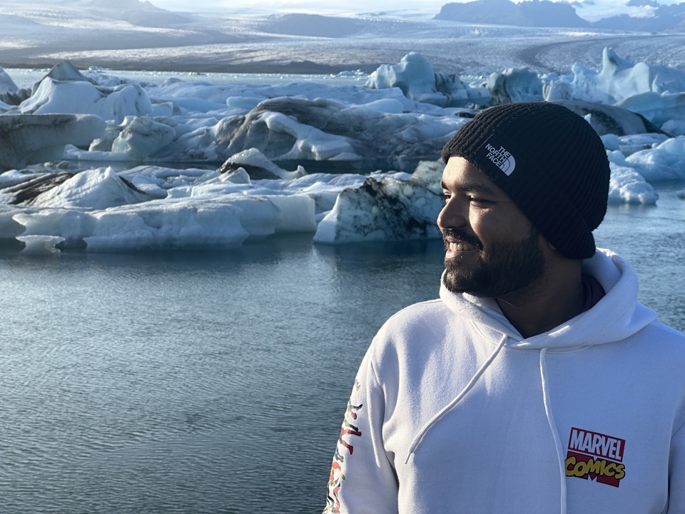 Man with Jokulsarlon glacier lagoon in the background.