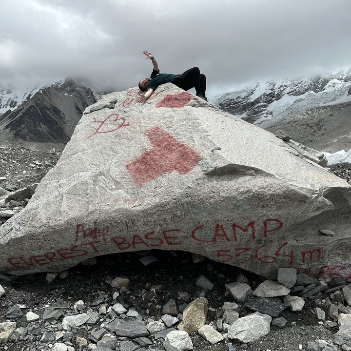 Close-up of a person on a rock at Everest Base Camp.