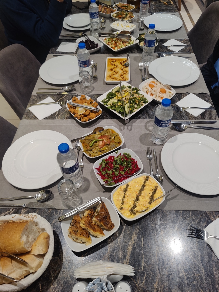 Table setting with various traditional dishes.