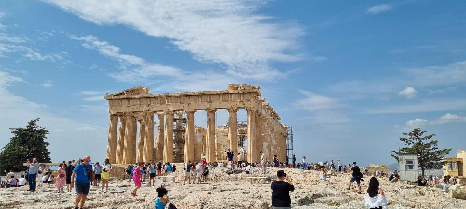 Tourists exploring the ancient Parthenon ruins.