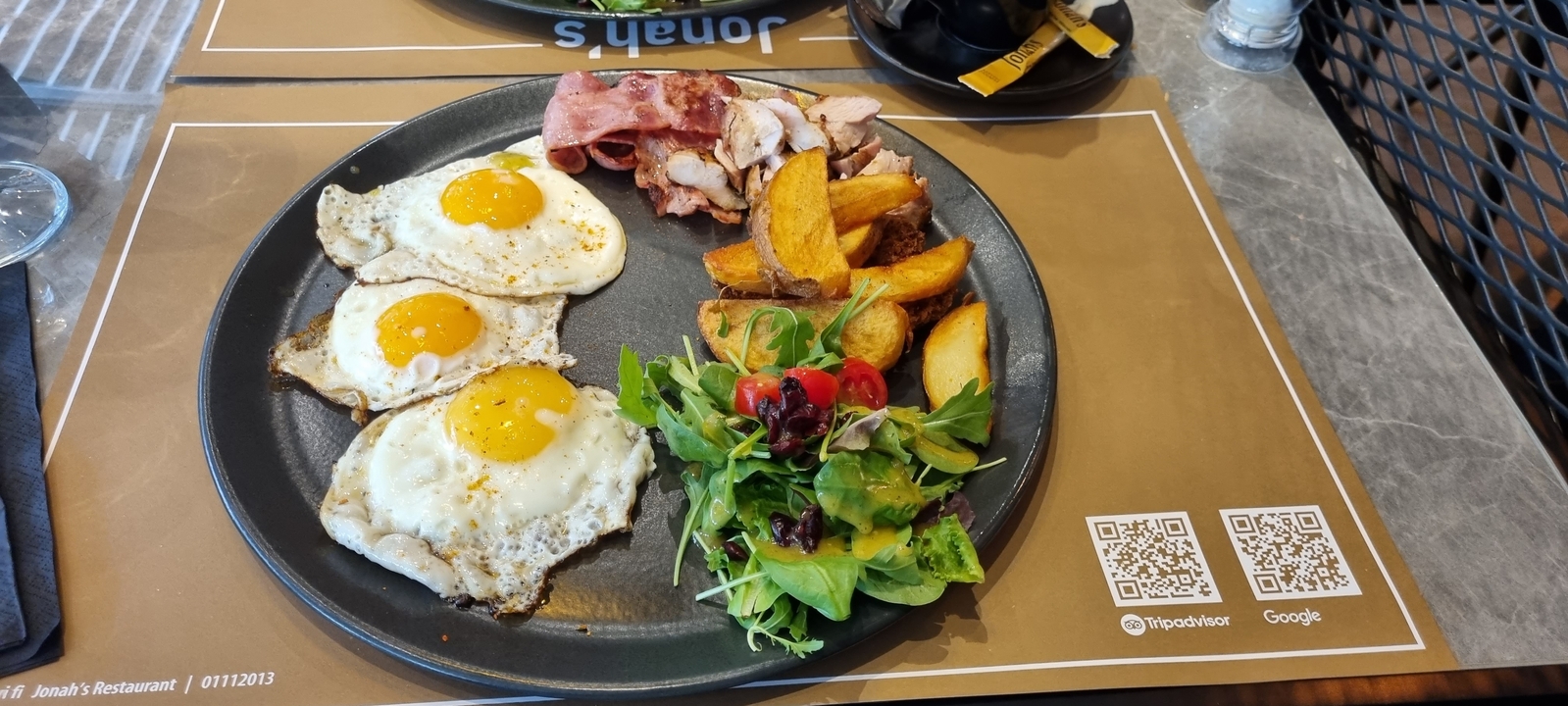 Plate of breakfast items including eggs and salad.