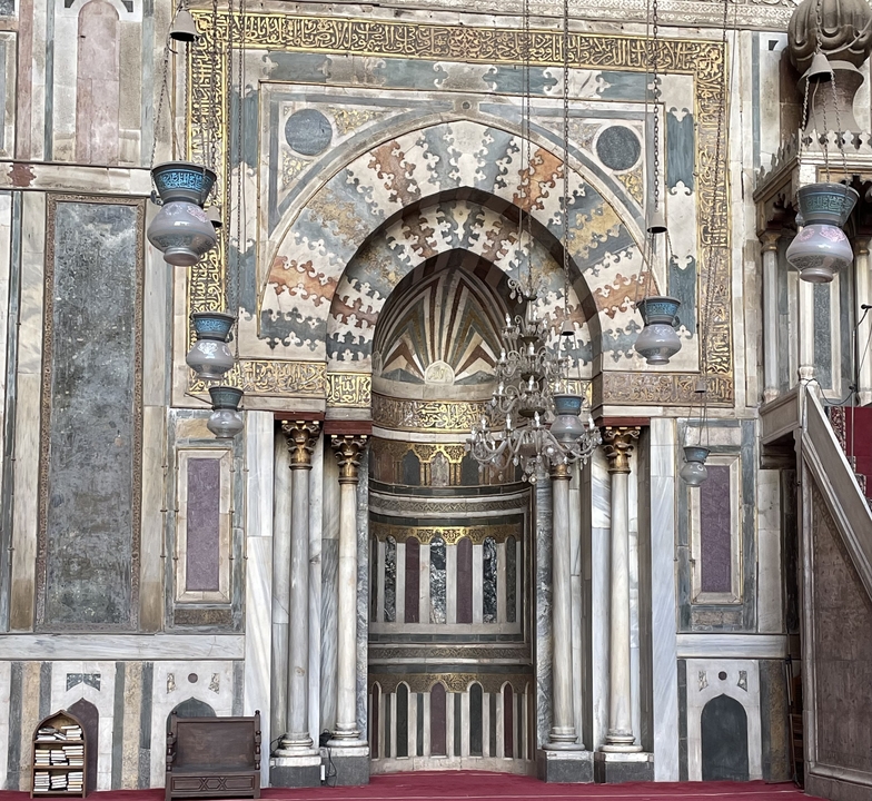 Ornate interior of a mosque with detailed carvings.