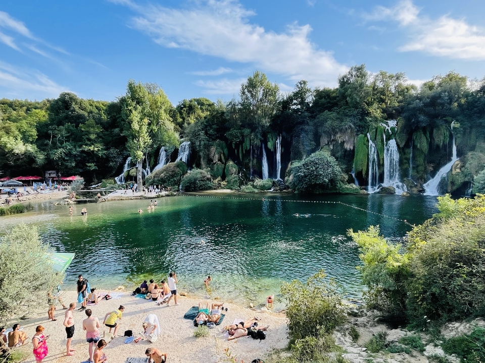 Beautiful waterfall with people enjoying nature.