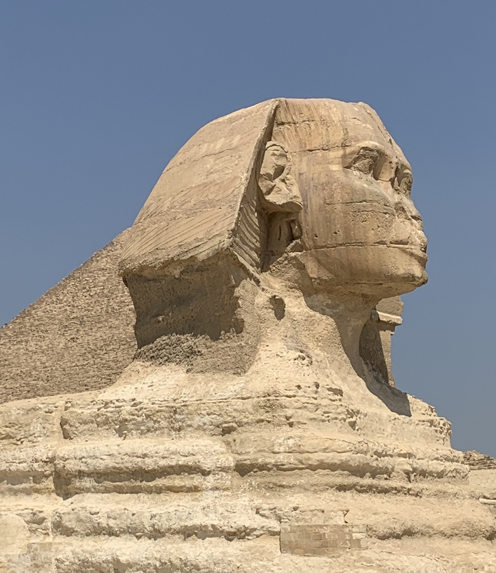 Sphinx with pyramid in the background.