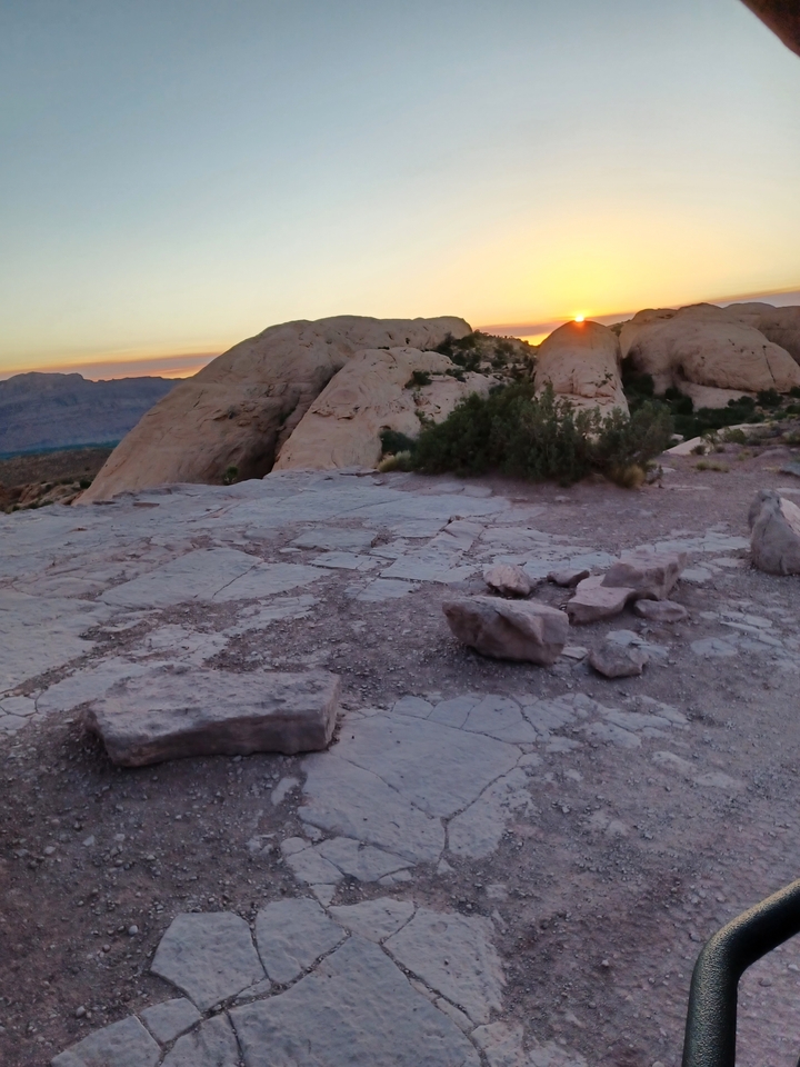 Rocky terrain with a sunset in the background.