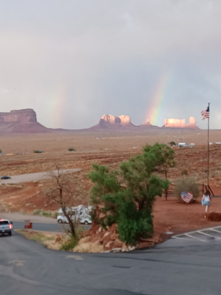 Blurry image of Monument Valley with a rainbow.